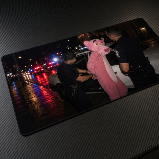 Pink Panther Costume Arrest Playmat at an angle on a gaming desk