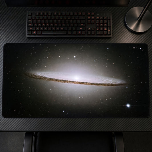 Sombrero Galaxy M104 (Hubble) Space Playmat at an angle on a gaming desk