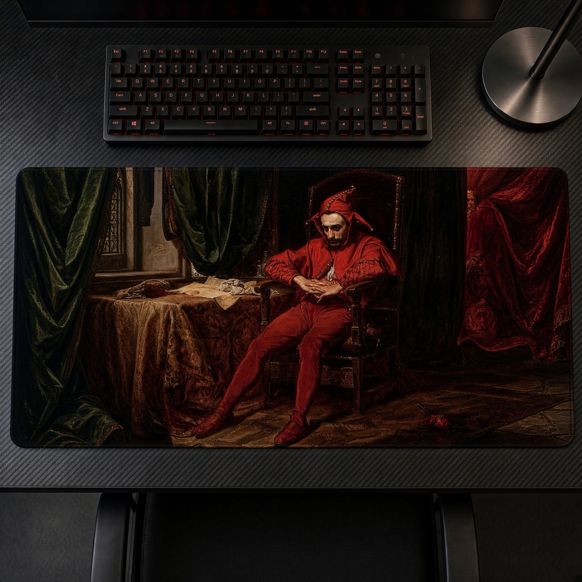 Brooding Red Jester Painting Playmat on a gaming desk, top-down view