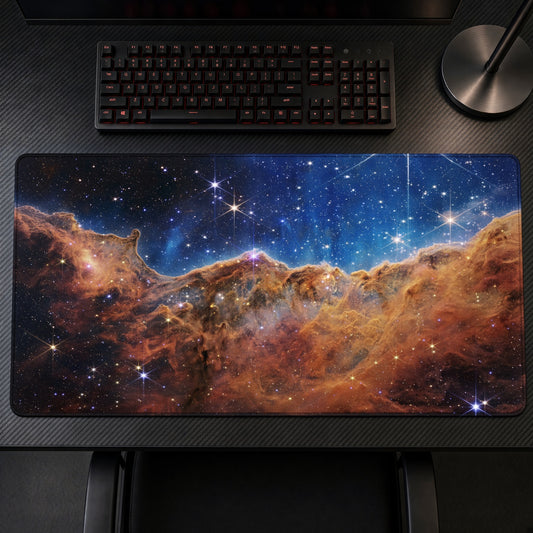 Cosmic Cliffs, Carina Nebula (Webb) Space Playmat on a gaming desk, top-down view