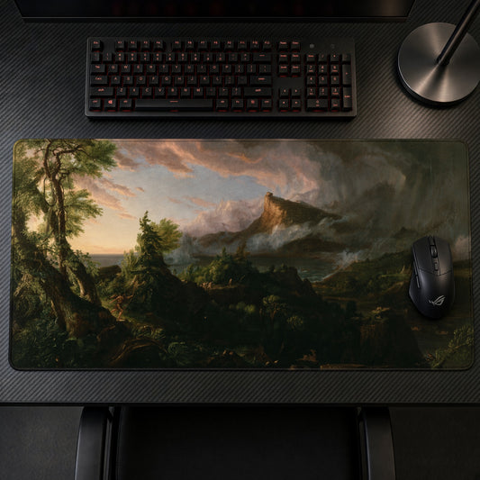 The Course of Empire: The Savage State Thomas Cole Playmat on a gaming desk, top-down view
