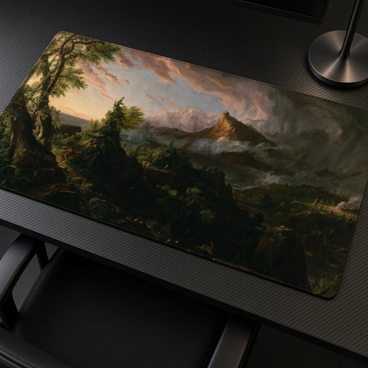 The Course of Empire: The Savage State Thomas Cole Playmat at an angle on a gaming desk