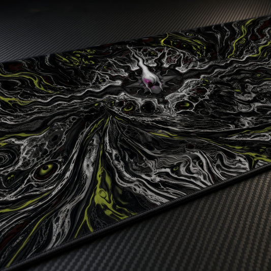 Dark Biomechanical Nightmare Playmat at an angle on a gaming desk
