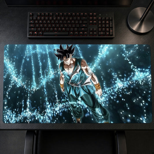 Goku Ultra Instinct playmat on a gaming desk, top-down view