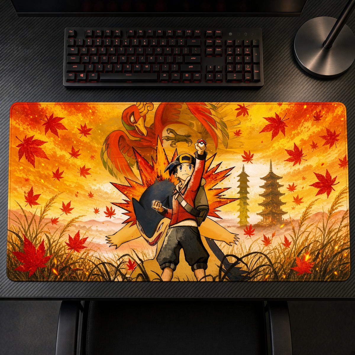 Ethan, Typhlosion and Ho-Oh Autumn Pokémon Playmat on a gaming desk, top-down view