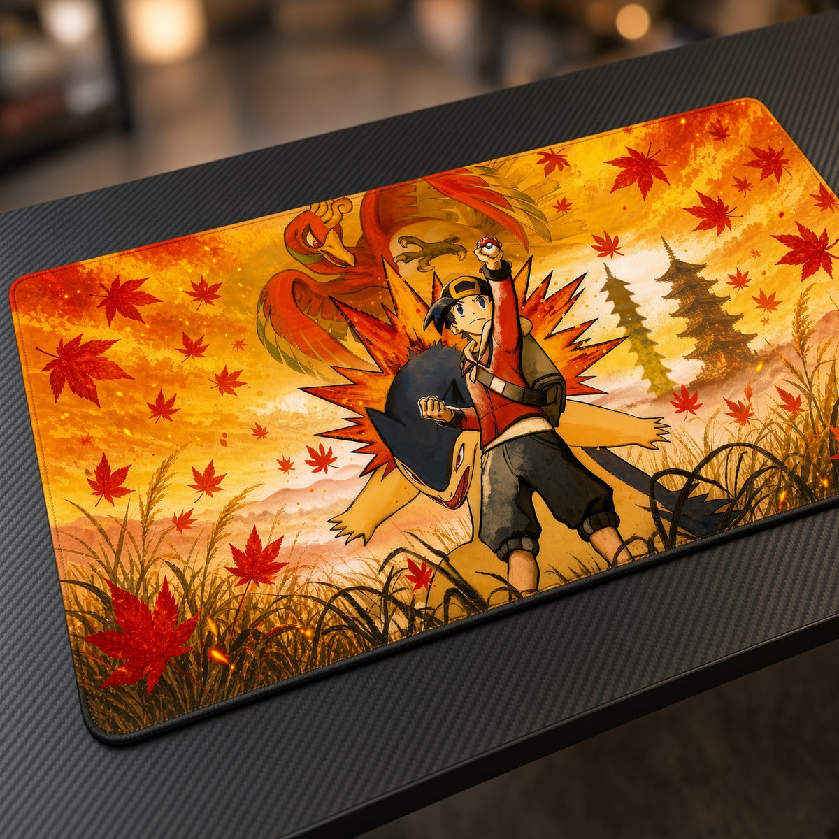 Ethan, Typhlosion and Ho-Oh Autumn Pokémon Playmat at an angle on a gaming desk
