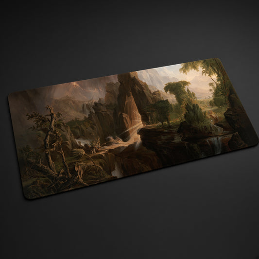 Expulsion from the Garden of Eden Thomas Cole Playmat at an angle on a gaming desk
