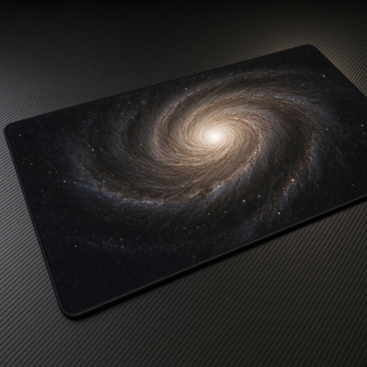 Golden Spiral Galaxy Space Playmat at an angle on a gaming desk
