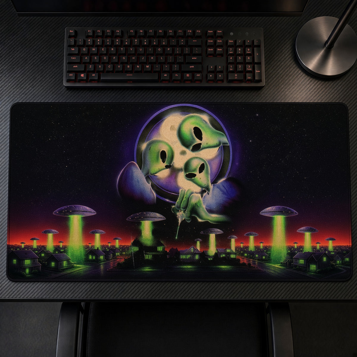 Green Aliens UFO Invasion Playmat on a gaming desk, top-down view
