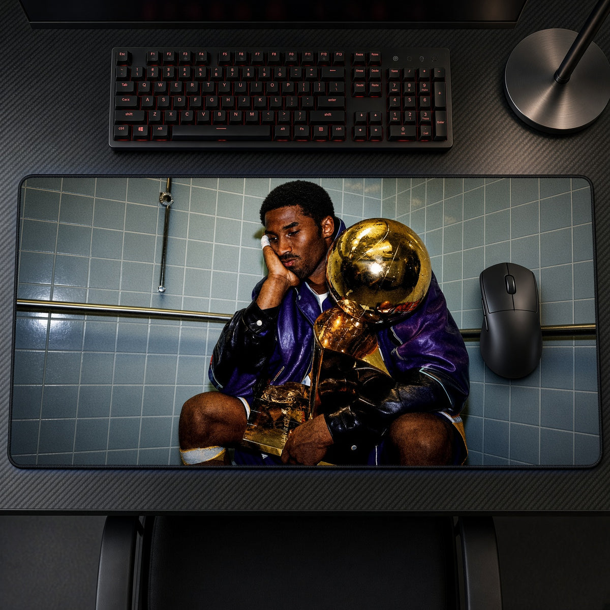 Kobe Bryant Championship Trophies Playmat on a gaming desk, top-down view