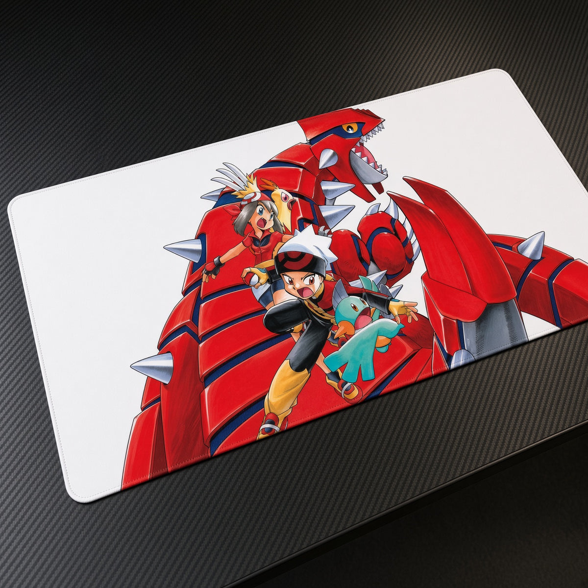 May, Brendan, Mudkip and Torchic with Groudon Pokémon Playmat at an angle on a gaming desk