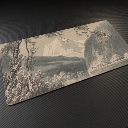 Near Grindelwald J. M. W. Turner Playmat at an angle on a gaming desk