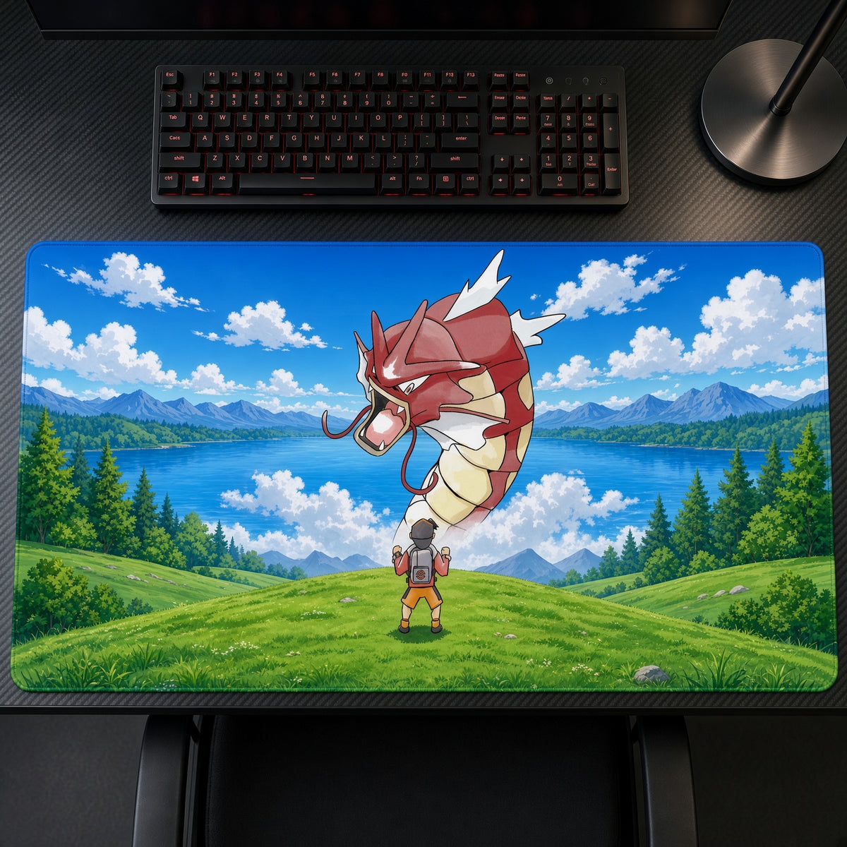 Red Gyarados Lakeside Encounter Pokémon Playmat on a gaming desk, top-down view