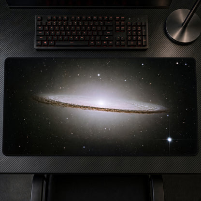 Sombrero Galaxy M104 (Hubble) Space Playmat at an angle on a gaming desk