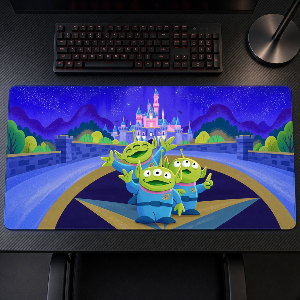 Toy Story Aliens Disney Castle Playmat on a gaming desk, top-down view