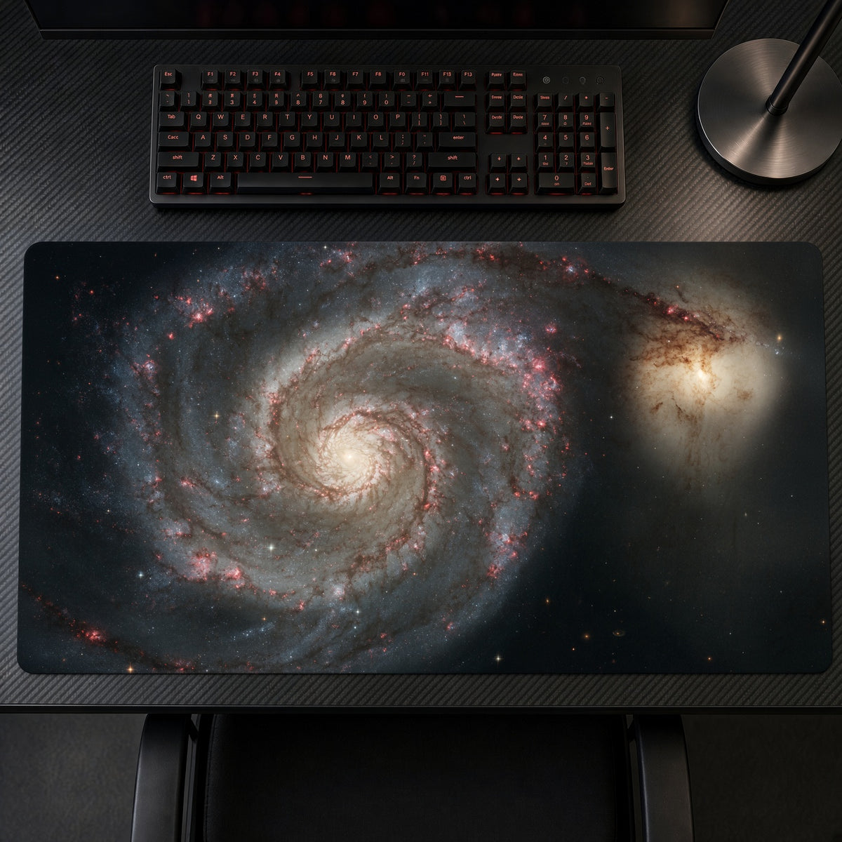 Whirlpool Galaxy M51 (Hubble) Space Playmat on a gaming desk, top-down view