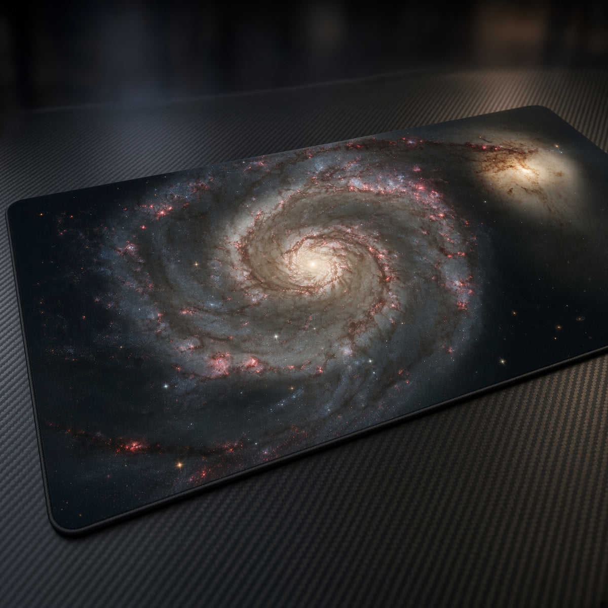 Whirlpool Galaxy M51 (Hubble) Space Playmat at an angle on a gaming desk