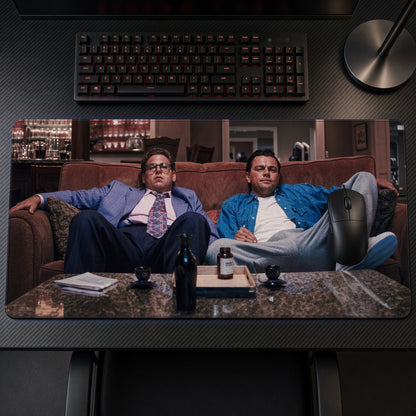 Wolf of Wall Street Couch Playmat on a gaming desk, top-down view